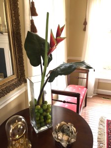 On a tabletop I have a single heliconia flower. Such vibrant colors, makes me feel warm. I filled the base with crabapples for some extra color.